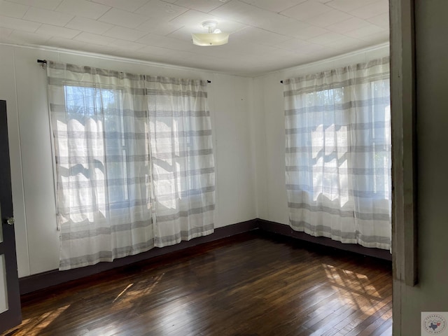 spare room featuring dark hardwood / wood-style floors