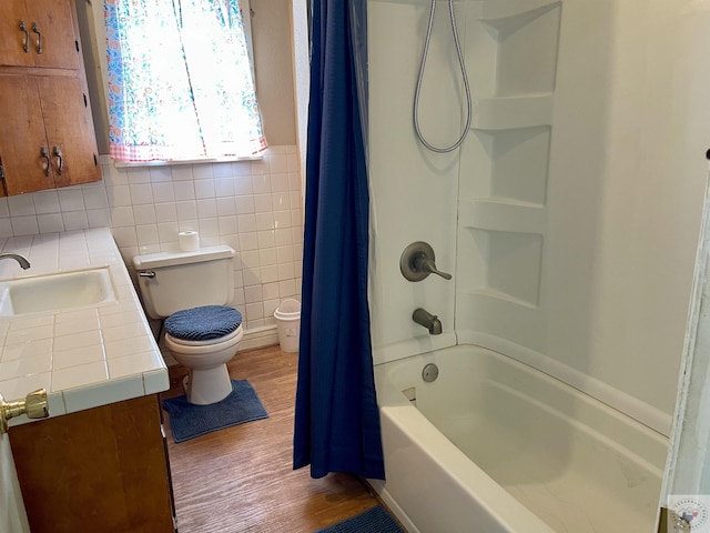 full bathroom featuring hardwood / wood-style flooring, toilet, vanity, and shower / bathtub combination with curtain