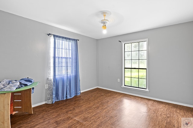 unfurnished room featuring dark wood-type flooring