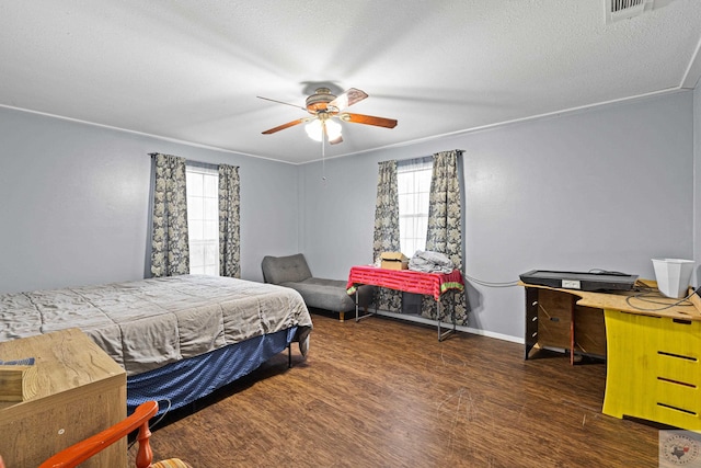 bedroom with ceiling fan, dark wood-type flooring, and a textured ceiling