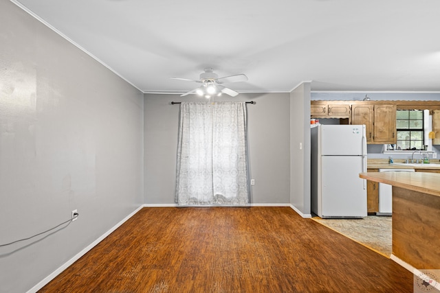 kitchen featuring dishwasher, white fridge, ceiling fan, crown molding, and light wood-type flooring