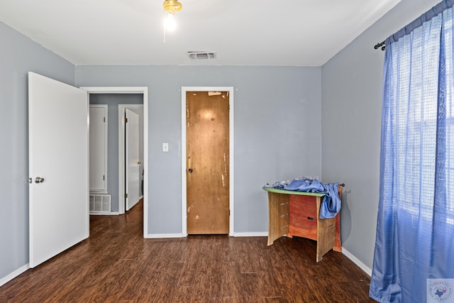 bedroom featuring dark wood-type flooring