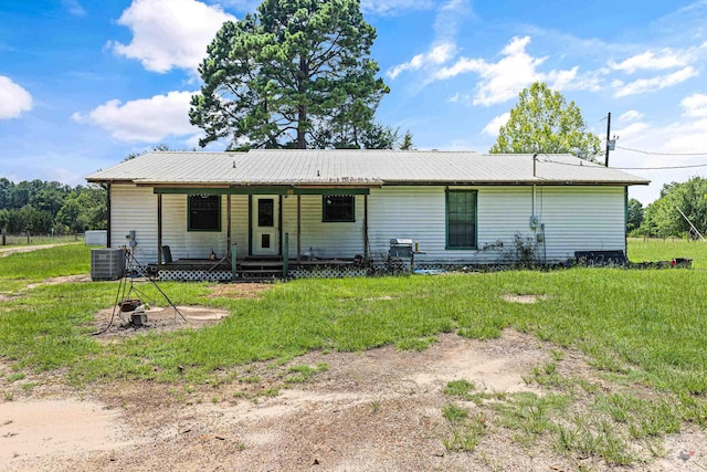 view of front facade with a porch, a front yard, and central air condition unit