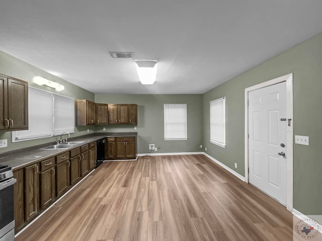 kitchen with black dishwasher, light hardwood / wood-style floors, sink, dark brown cabinets, and white range with gas stovetop