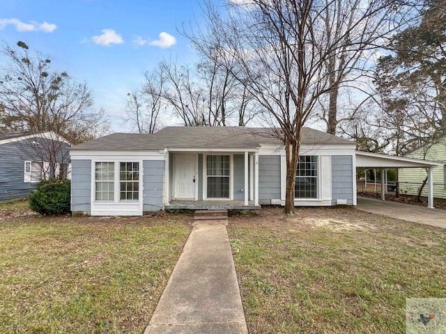 single story home with a front lawn and a carport