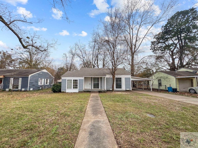 view of front of property with a front yard and a carport