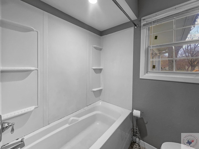 bathroom with toilet and shower / tub combination