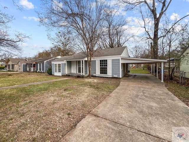 view of front of property with a front lawn and a carport