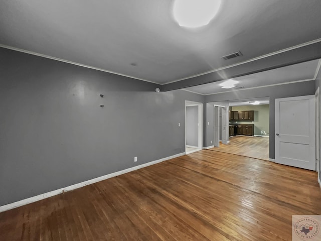 interior space with wood-type flooring and ornamental molding