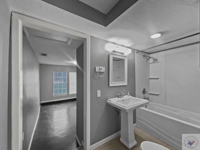 bathroom with toilet, shower / bathtub combination, and a textured ceiling