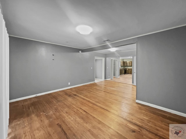 interior space with hardwood / wood-style flooring and ornamental molding