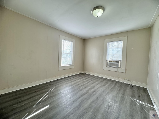 empty room featuring dark wood-type flooring and cooling unit