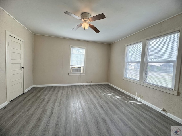 empty room featuring hardwood / wood-style flooring, ceiling fan, and cooling unit