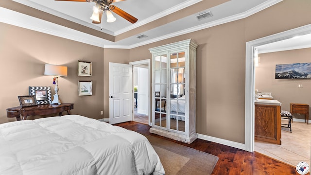 6914 Manor Crest Dr, Texarkana, AR 71854 - bedroom featuring baseboards, crown molding, wood finished floors, a tray ceiling, and a ceiling fan
