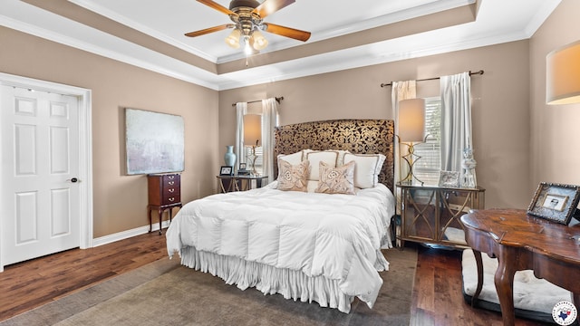 6914 Manor Crest Dr, Texarkana, AR 71854 - bedroom featuring wood finished floors, a tray ceiling, ornamental molding, ceiling fan, and baseboards