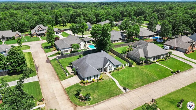 6914 Manor Crest Dr, Texarkana, AR 71854 - aerial perspective of suburban area featuring a heavily wooded area