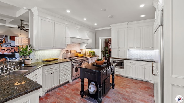 6914 Manor Crest Dr, Texarkana, AR 71854 - kitchen with stainless steel appliances, a sink, brick flooring, custom exhaust hood, and ceiling fan
