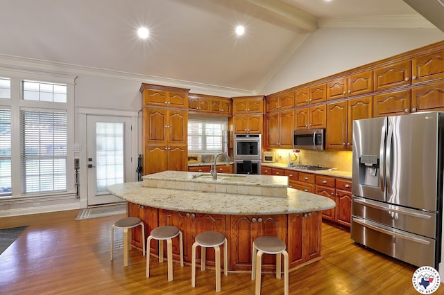 16 Bill Rogers Dr, Texarkana, TX 75503 - kitchen with stainless steel appliances, a sink, dark wood finished floors, an island with sink, and a breakfast bar area