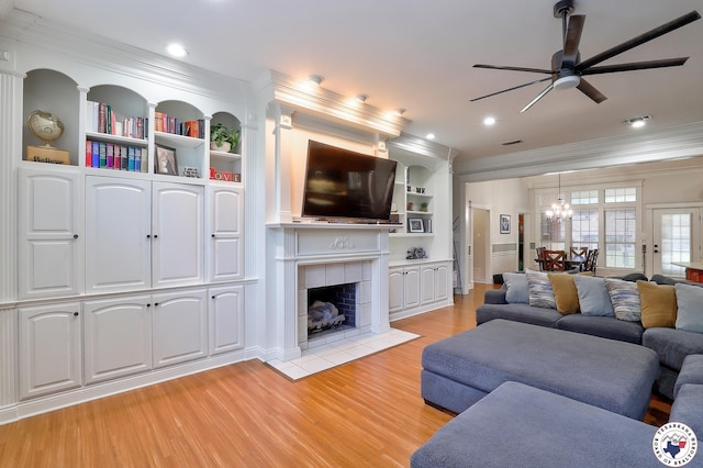 16 Bill Rogers Dr, Texarkana, TX 75503 - living area with ornamental molding, ceiling fan, light wood finished floors, a tiled fireplace, and a chandelier