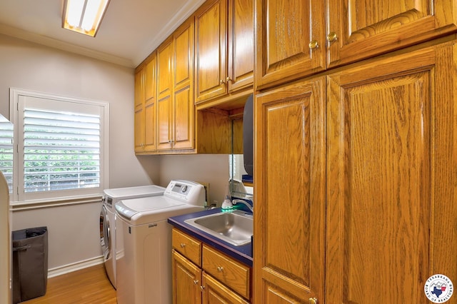 16 Bill Rogers Dr, Texarkana, TX 75503 - laundry area featuring washing machine and clothes dryer, cabinet space, light wood-style floors, baseboards, and crown molding