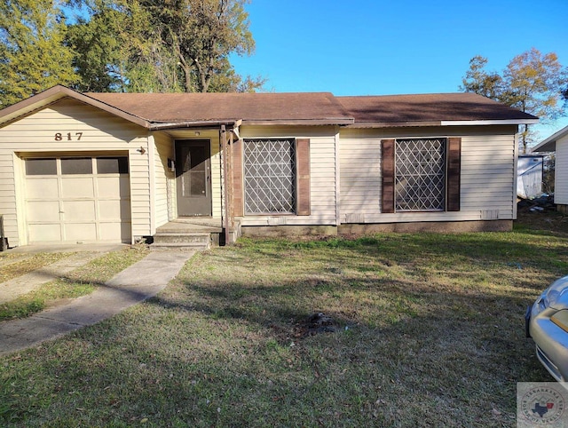 ranch-style house with a garage and a front lawn