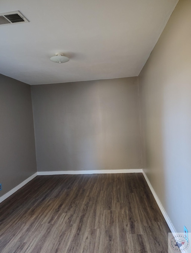 empty room featuring dark wood-type flooring