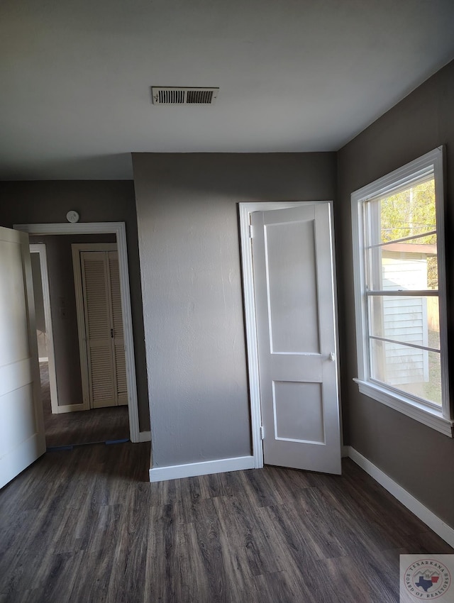 unfurnished room featuring dark wood-type flooring