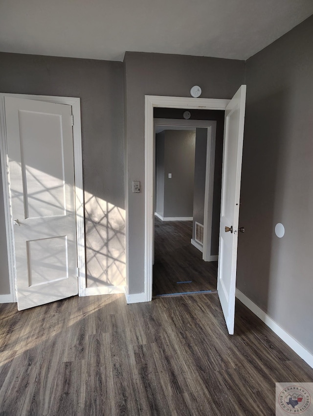 empty room featuring dark hardwood / wood-style flooring