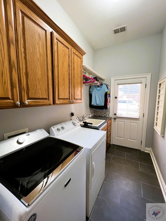 laundry room featuring sink, cabinets, dark tile patterned flooring, and washer and dryer