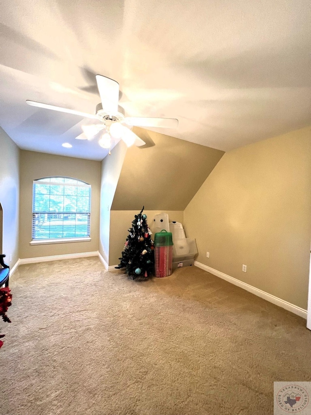 bonus room with ceiling fan, carpet flooring, and vaulted ceiling