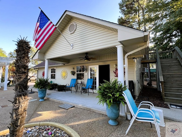 rear view of property with ceiling fan and a patio