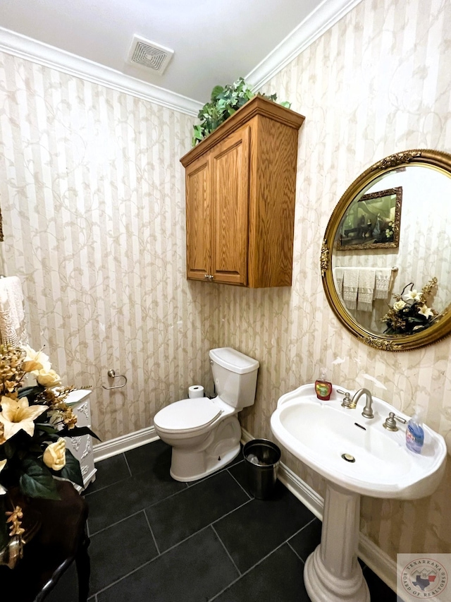 bathroom featuring toilet, crown molding, and tile patterned flooring