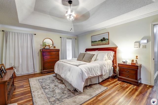 3502 Tiffany Ln, Texarkana, AR 71854 - bedroom featuring a raised ceiling, a textured ceiling, light wood-style floors, crown molding, and ceiling fan