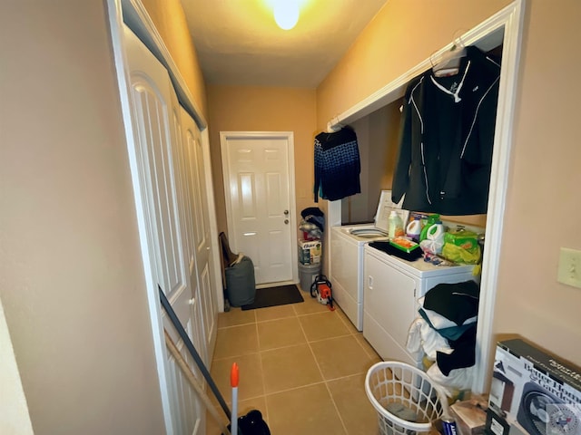 laundry room with light tile patterned floors and washing machine and clothes dryer