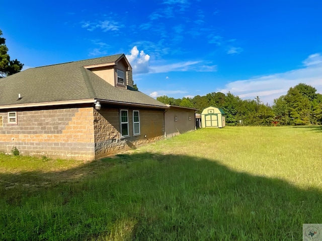 view of home's exterior featuring a storage shed and a yard