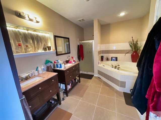 bathroom with tile patterned floors, vanity, and separate shower and tub