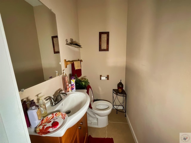 bathroom with toilet, tile patterned flooring, and vanity