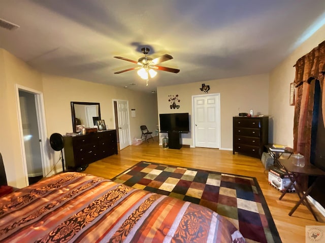 bedroom with ceiling fan and hardwood / wood-style floors