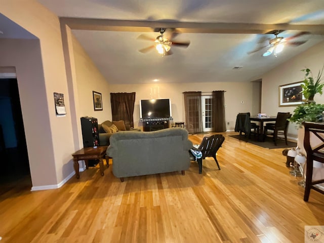 living room featuring hardwood / wood-style flooring, lofted ceiling, and ceiling fan