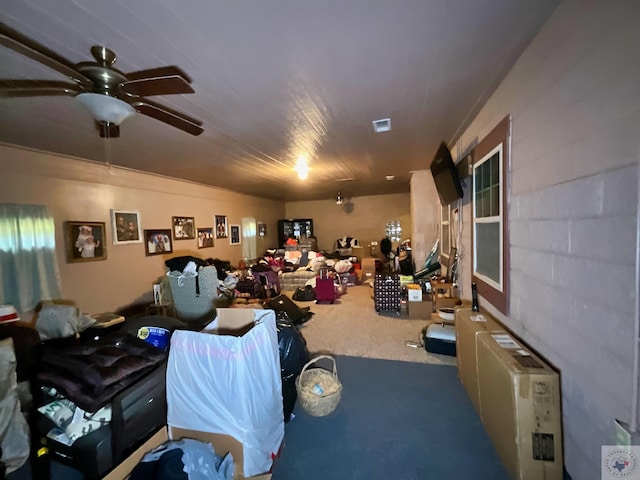 interior space featuring ceiling fan and carpet