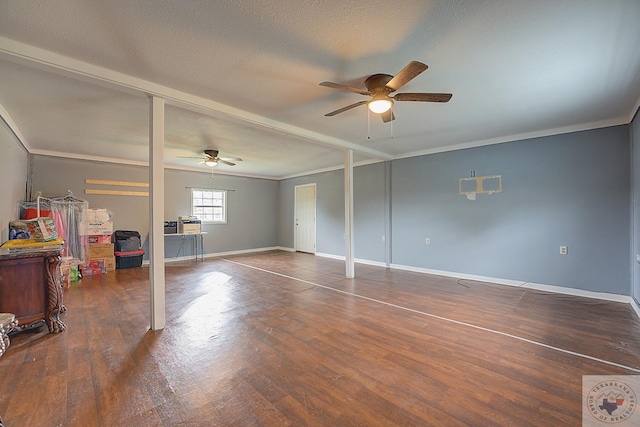 interior space with crown molding, dark wood-type flooring, and ceiling fan