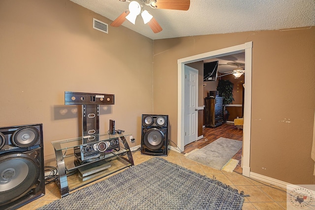 interior space featuring a textured ceiling and ceiling fan