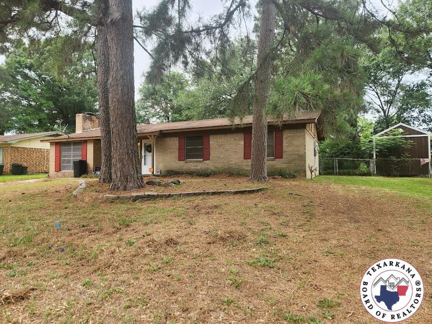 1305 E 47th St, Texarkana, AR 71854 - single story home with brick siding and a chimney