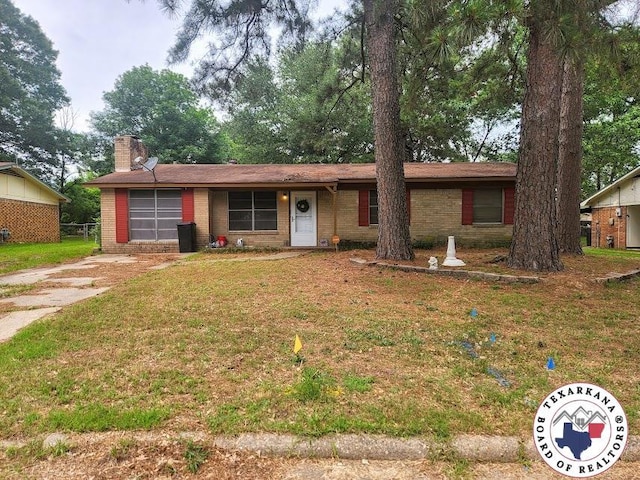 1305 E 47th St, Texarkana, AR 71854 - single story home with brick siding, a chimney, a front yard, and concrete driveway
