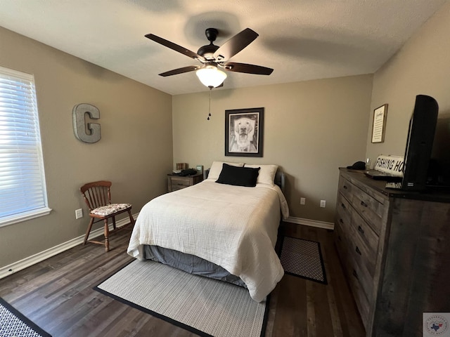 bedroom with ceiling fan and dark hardwood / wood-style flooring