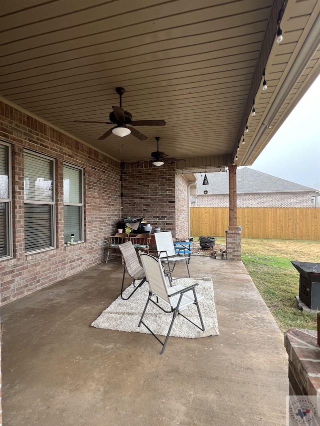 view of patio / terrace with a fire pit and ceiling fan