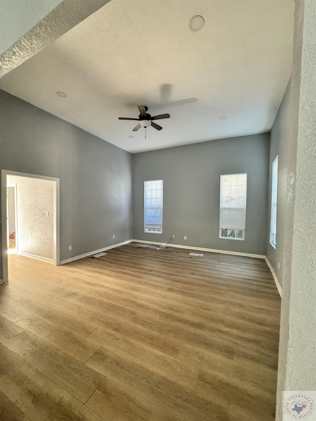 unfurnished room featuring hardwood / wood-style flooring, a textured ceiling, and ceiling fan