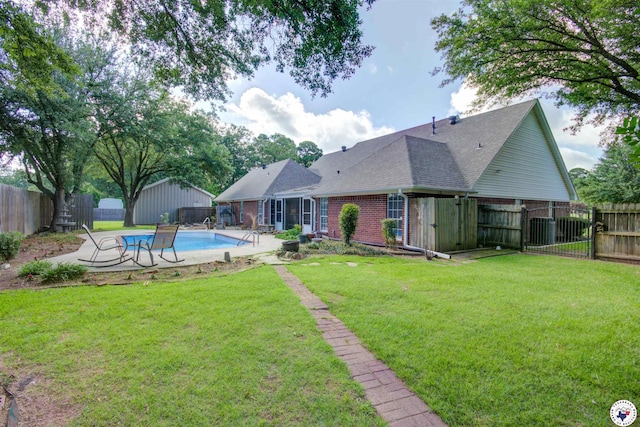 14 White Willow Pl, Texarkana, AR 71854 - rear view of house featuring a fenced backyard, brick siding, roof with shingles, and a patio area