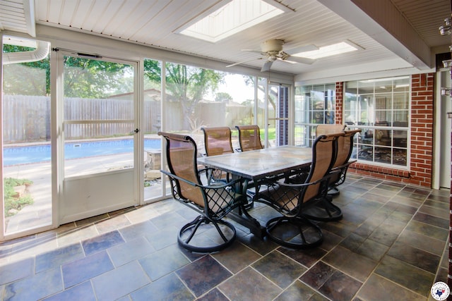 14 White Willow Pl, Texarkana, AR 71854 - sunroom / solarium with a skylight, outdoor dining space, ceiling fan, and stone finish floors
