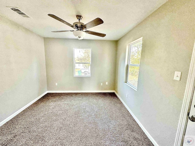 empty room featuring carpet floors, a textured ceiling, and ceiling fan